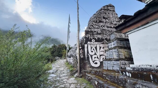 Large mani stone with Buddhist mantras on mountain trail in Himalayas, Nepal