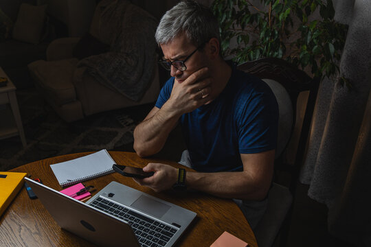 Freelancer reacting with frustration while working on laptop