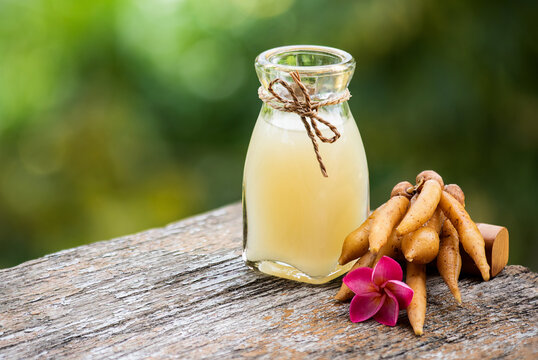 Fingerroot rhizomes and fingerroot juice on natual background.