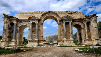 Fototapeta premium The unique three-arched Victory Gate to the ancient Anavarza city in Dilekkaya village of Kozan district in Adana province (Turkey). Once marked the entrance to one of largest Roman cities in the anci