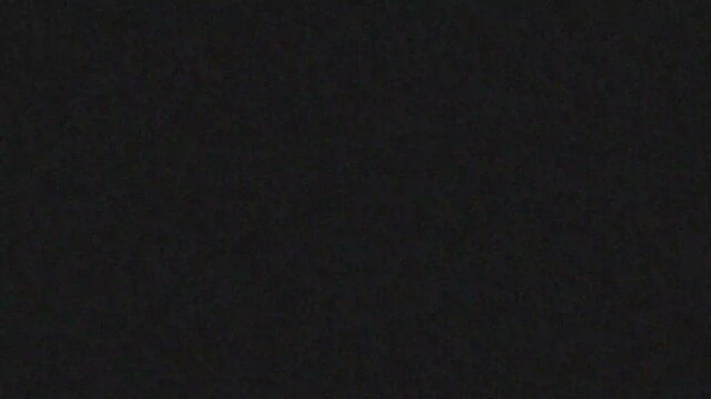 Minimalist abstract dark background with subtle grey noise texture and vintage film grain, ideal for cinematic movie credits and luma matte video overlays. 4k