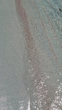 Crystal-clear water and red sand at Spiaggia di Punta Molentis in Sardinia