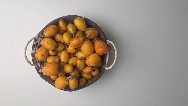 Hand holding loquats. Yellow fruit hand. medlar in hand, close-up. High quality photo