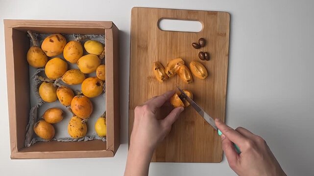 Hand holding loquats. Yellow fruit hand. medlar in hand, close-up. High quality photo