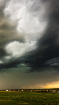 Turbulent storm clouds swirling overhead before heavy rainfall begins
