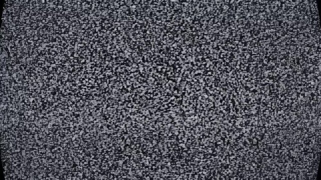 A detailed close-up showcases a textured surface composed of numerous small, irregularly shaped particles in varying shades of gray, creating a granular and slightly chaotic aesthetic.
