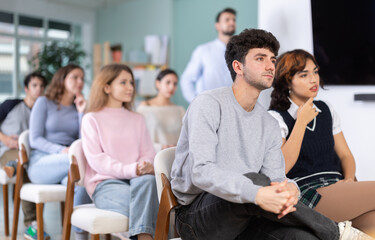 Fototapeta premium Engaged young man paying attention and listening during a classroom training session