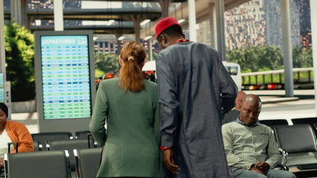 Two travelers colliding accidentally in busy bus station hall filled with luggage, dramatic public transportation scene showing crowded passenger flow. Crossing paths in a hectic terminal.