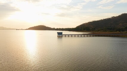 Ban bang phra reservoir at golden hour with glimmering water and distant hills