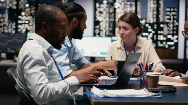 Business manager leading multiracial team, fostering teamwork and positive office culture. Management executive in boardroom supervising administrative staff, delegating tasks and reviewing KPIs.