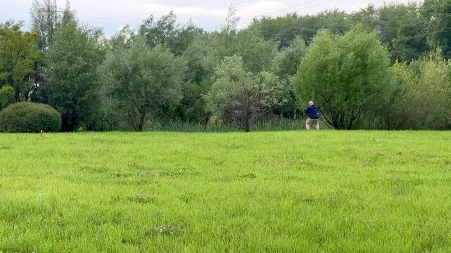 Man meditating karate practice on grass solitary practitioner rehearses hand-to-hand combat techniques and controlled stances