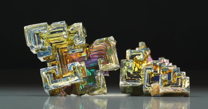 Bismuth crystals. Bismuth - chemical element with symbol Bi and atomic number 83. Post-transition metal and one of pnictogens. Synthesized bismuth crystal. Iridescent coloration is due to oxide film