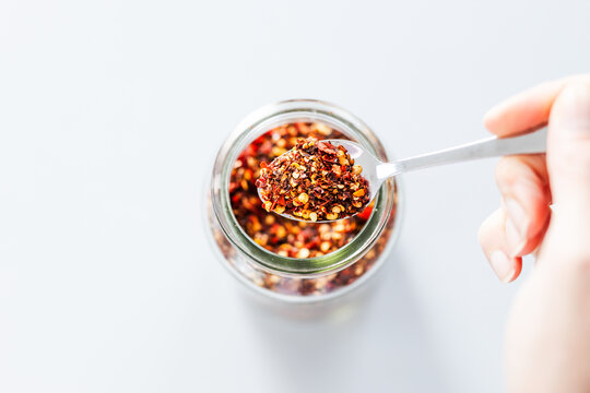 chilli flakes in glass pantry jar, top down close up