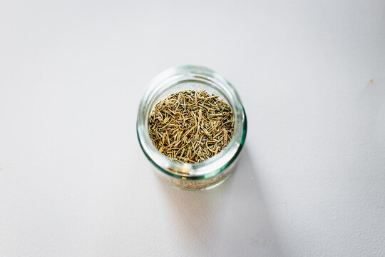 dried rosemary in glass pantry jar, top down close up