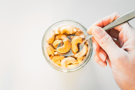 salted cashews in glass pantry jar; top down close up