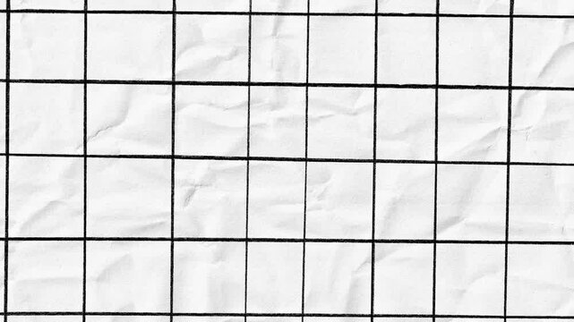 Crumpled white paper with hand drawn black grid lines stop motion. Graph sheet drawing on creased surface.