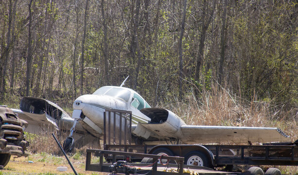 Derelict twin-engine aircraft in a junk yard 