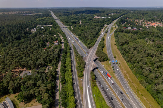 Aerial of A28 freeway in Dutch moorland sand landscape of Leusden near Amersfoort. Traffic and artery interstate seen from above.