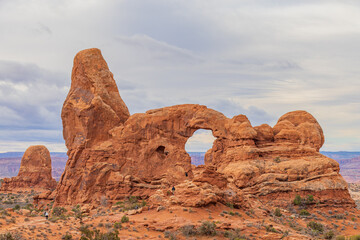 Hikers explore the landscape beneath the Turret Arch © Kit Leong