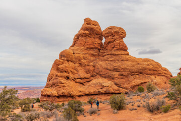 Hikers explore the red rock landscape near Turret Arch in Arches National Park © Kit Leong