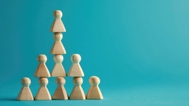 A pyramid of wooden pawns is meticulously arranged illustrating concepts of organizational hierarchy business structure leadership progression and cooperative teamwork