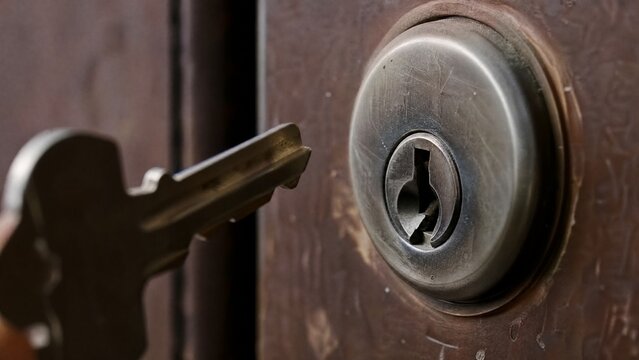 misaligned. A metal key slightly misaligned with a door lock's keyhole in dim light. product launch decks, UI/UX mockups, designed for data visualization dashboards and holographic UIs.