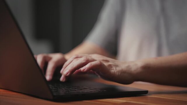 Hand typing on laptop for coding, searching e-learning about artificial intelligence, while the dedicated programmer completes a complex task, working closely on modern software development.