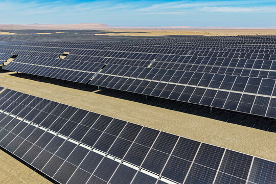 Mechanized solar panel array with trackers in sunny arid desert