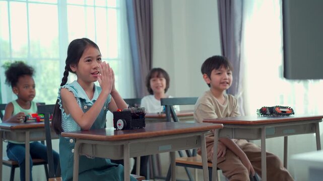 Happy school children participating in interactive STEM lesson
