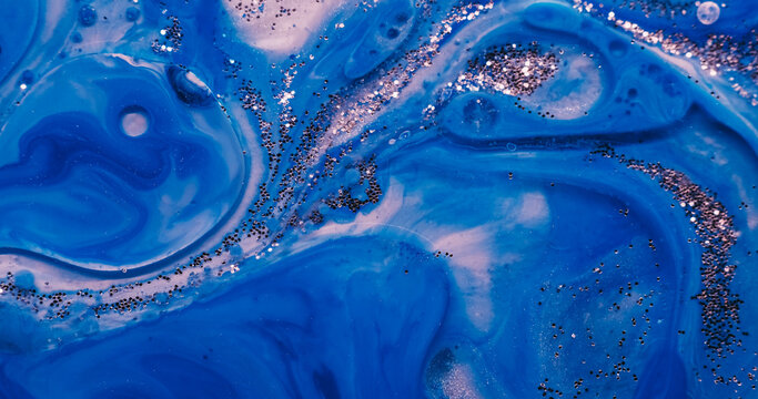 Blue paint water. Sequins background. Blur color pigment in acrylic marble glitter fluid round texture flowing on creative art abstraction.