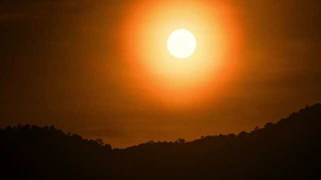 Mountain sunset time-lapse with flowing mist and golden hour light hitting the ridges.