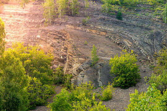 Folded sedimentary strata and scree slope on Cheese Mountain geological formation near Mozukha in Kemerovo Oblast