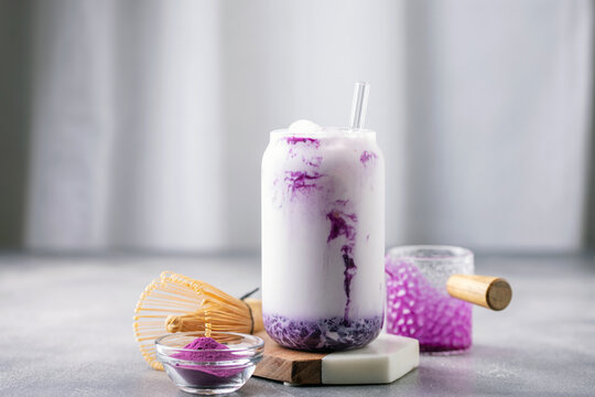 Ube latte in glass. Healthy vegan drink. Viral trendy asian beverage