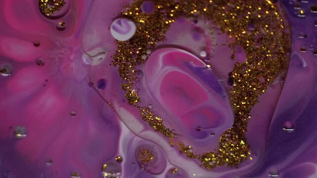 Drop emulsion. Shimmering fluid. Oil glitter spot floating on paint colorful liquid. Art mix powder pigment glamour abstract background.