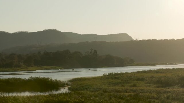 Panning shot of river landscape at sunrise in Zambia