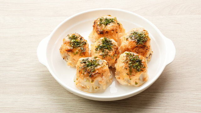 Dimsum with Japanese Mentai Sauce. Served on plate.