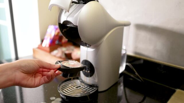 Removing a Used Coffee Pod from a Modern Espresso Machine