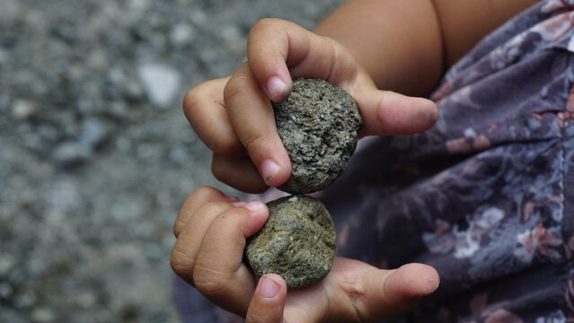hand of the child keeping the stone