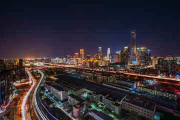 Fototapeta premium Night view of the China Zun and Guomao architectural complex in Beijing's CBD, a panoramic view of a bustling first-tier city commercial center.