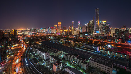 Fototapeta premium Night view of the China Zun and Guomao architectural complex in Beijing's CBD, a panoramic view of a bustling first-tier city commercial center.