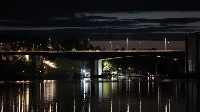 Stockholm, Sweden A night view of Lake Malaren with reflections of the landmark E4 and Essingeleden bridge.