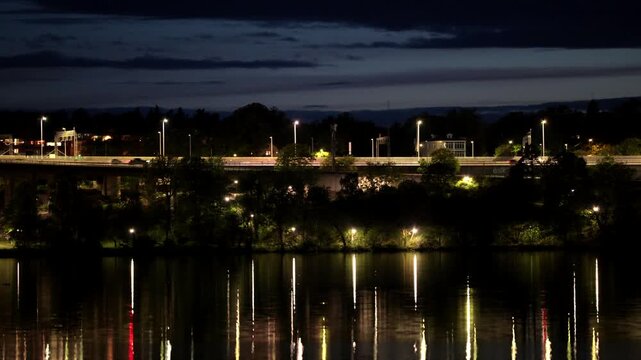 Stockholm, Sweden A night view of Lake Malaren with reflections of the landmark E4 and Essingeleden bridge.