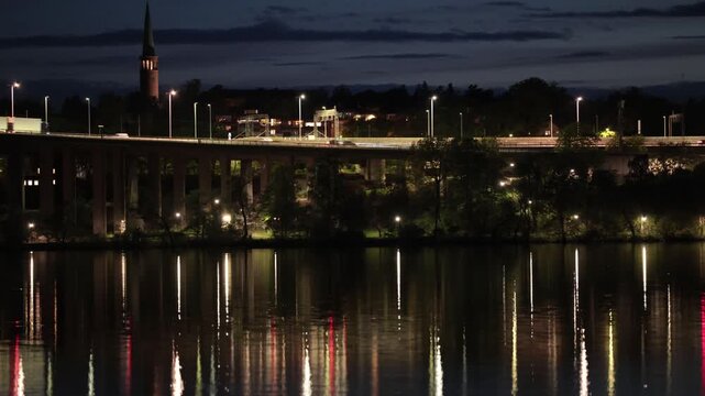 Stockholm, Sweden A night view of Lake Malaren with reflections of the landmark E4 and Essingeleden bridge.