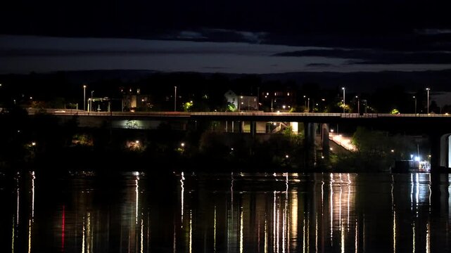 Stockholm, Sweden A night view of Lake Malaren with reflections of the landmark E4 and Essingeleden bridge.