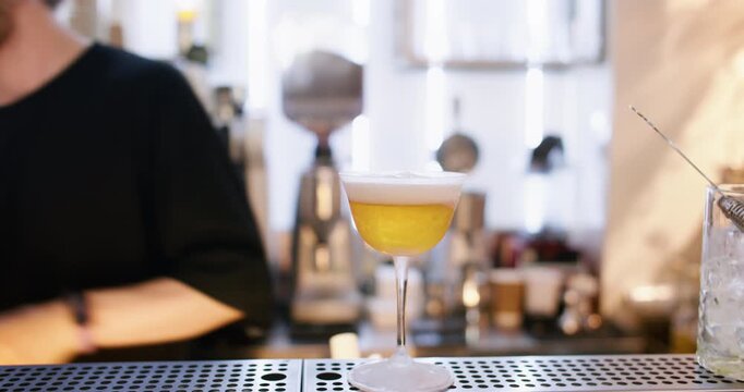 Mixologist work. Cocktail foam. Bartender adding whipped cream milk top with siphon dispenser to flavored beverage adding dried garnish.