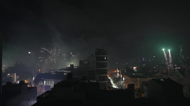 Multiple Simultaneous Tet Fireworks over Night cityscape in Vietnam