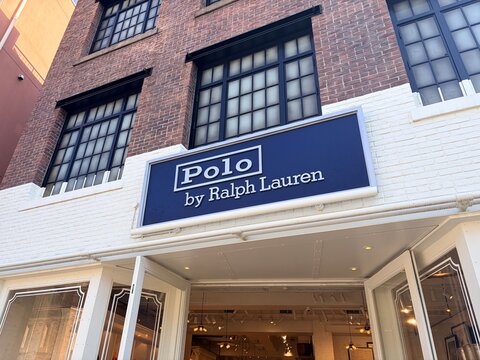 Polo by Ralph Lauren flagship store exterior with blue corporate logo sign and classic brick facade detail in Shibuya shopping district - Tokyo, Japan, February 21, 2026