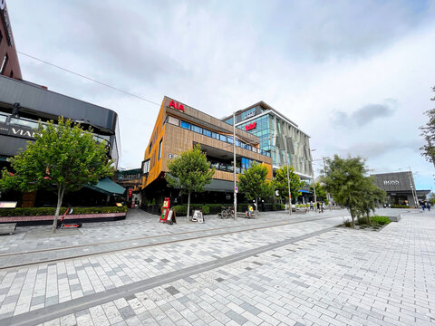 Modern commercial architecture and retail buildings featuring AIA and KPMG logos on Cashel Street in the Christchurch central business district - Canterbury, New Zealand, March 7, 2023