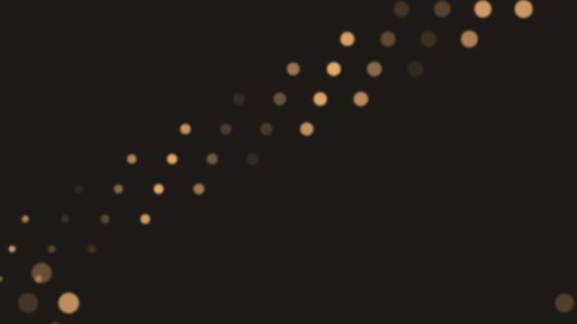 A diagonal string of soft golden bokeh lights against a dark background