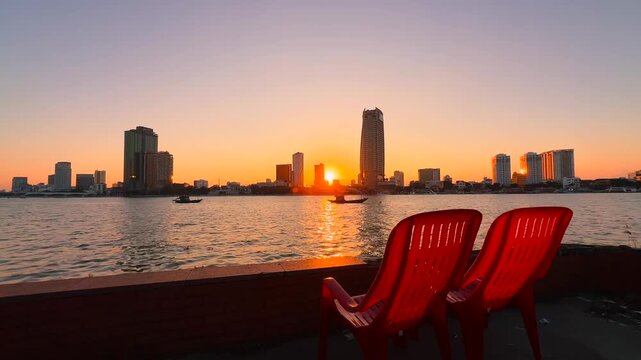 Two Red Riverside Plastic Chairs for watching Sunset over Han River and Cityscape